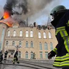 Emergency responders face a building and fire. 