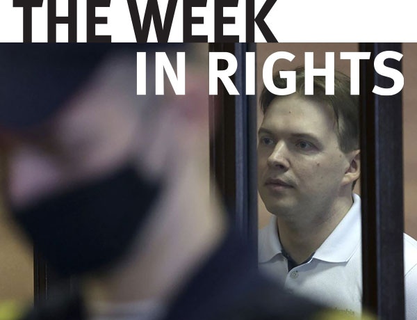 Maksim Znak appears behind bars. 