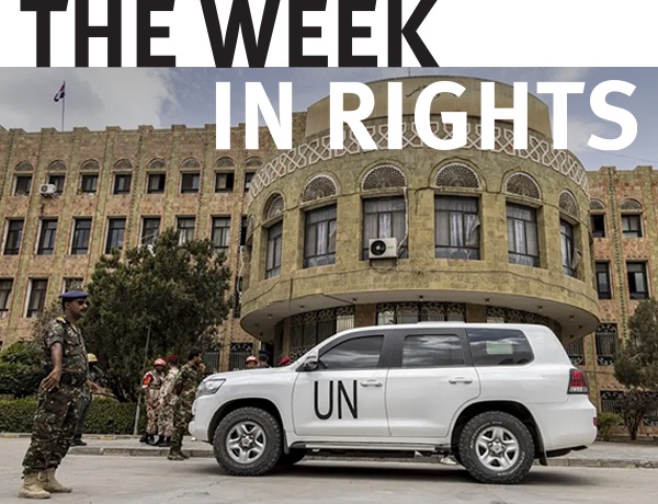 United Nations vehicle is stopped in front of military personnel. 